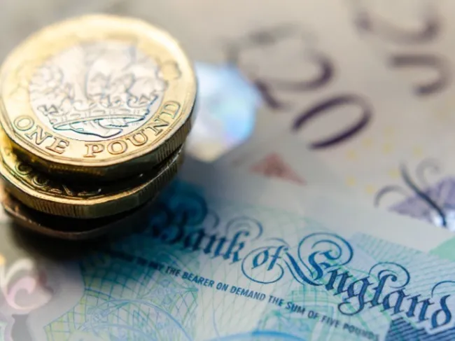 Bank Of England note with coins